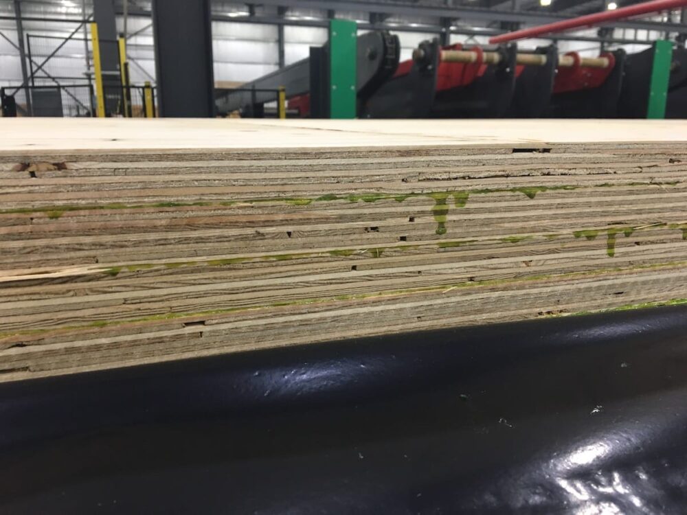 Close-up of the edge of stacked Mass Ply Panel sheets.