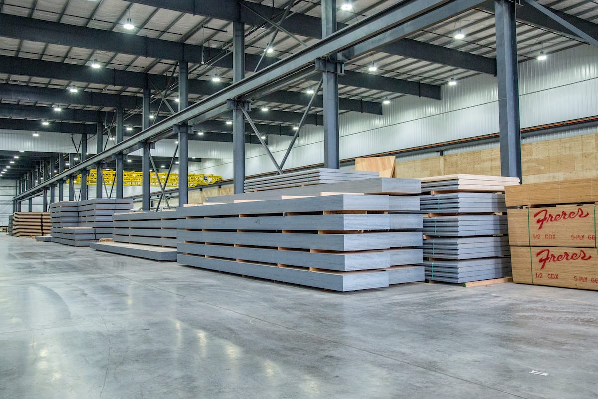 Stacks of mass timber panels stored inside the Freres Engineered Wood. manufacturing facility.