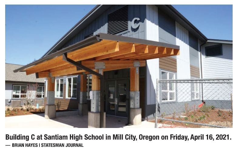 Exterior view of Building C at Santiam High School with a wood-framed entrance and metal roof.